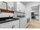Well-lit laundry room features a granite countertop, white cabinets, and modern washer and dryer at 88 Priscilla Ln, Fuquay Varina, NC 27526