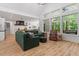 Bright living room with high ceilings, large windows, and an open floor plan to the kitchen at 88 Priscilla Ln, Fuquay Varina, NC 27526