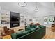 Spacious living room with a modern fireplace, built-in shelves, and a comfortable green sofa at 88 Priscilla Ln, Fuquay Varina, NC 27526