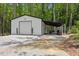 Spacious outbuilding featuring a roll-up door and covered parking, ideal for storage or workshop at 88 Priscilla Ln, Fuquay Varina, NC 27526
