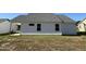 Rear exterior view of a home with covered patio and white siding, complemented by a well-manicured lawn at 91 Oakfield Trace Dr, Four Oaks, NC 27524