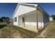 White exterior features a covered patio with wooden pillars at 91 Oakfield Trace Dr, Four Oaks, NC 27524