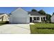 Charming single-story home with a two-car garage, inviting front porch, and well-maintained lawn at 91 Oakfield Trace Dr, Four Oaks, NC 27524