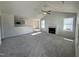 Spacious living room featuring neutral carpet, a fireplace, large windows, and a breakfast bar at 91 Oakfield Trace Dr, Four Oaks, NC 27524