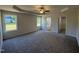 Bright main bedroom features a tray ceiling, ceiling fan, and en suite bathroom with walk-in closet at 91 Oakfield Trace Dr, Four Oaks, NC 27524