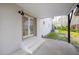Rear view of a two-story home with a concrete patio and access door at 947 Manchester Dr, Cary, NC 27511