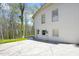 Rear view of a two-story home with a concrete patio and access door at 947 Manchester Dr, Cary, NC 27511