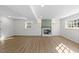Spacious basement featuring a decorative fireplace, recessed lighting, and wood-look flooring at 947 Manchester Dr, Cary, NC 27511