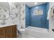 Modern bathroom with blue tiled walls and tub, designer wallpaper and vanity at 947 Manchester Dr, Cary, NC 27511