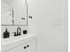 Modern bathroom with vanity, black fixtures, white countertop, and sleek mirror at 947 Manchester Dr, Cary, NC 27511