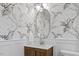 Elegant bathroom featuring patterned wallpaper, a wood vanity, and modern fixtures at 947 Manchester Dr, Cary, NC 27511