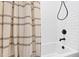Classic bathroom features a tub and shower with a striped curtain and herringbone tile wall at 947 Manchester Dr, Cary, NC 27511