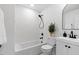 Modern bathroom with subway tile surround, shower-tub combo, and white vanity at 947 Manchester Dr, Cary, NC 27511