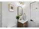 Stylish bathroom with wood vanity, framed mirror, and modern fixtures at 947 Manchester Dr, Cary, NC 27511