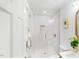 Bright bathroom boasts a glass shower with gold fixtures, white tile and decor at 947 Manchester Dr, Cary, NC 27511