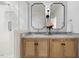 Bright bathroom featuring a dual sink vanity with framed mirrors and a tiled walk-in shower at 947 Manchester Dr, Cary, NC 27511