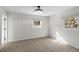 Clean bedroom featuring neutral walls, two windows, and carpeted floors at 947 Manchester Dr, Cary, NC 27511