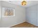 Bright bedroom with light blue accent wall, wooden floors, and a large window at 947 Manchester Dr, Cary, NC 27511