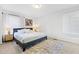 Neutral bedroom features a queen bed, two windows, carpeted floors and a large rug at 947 Manchester Dr, Cary, NC 27511
