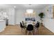 Charming dining area with modern chandelier, seating, and hardwood floors at 947 Manchester Dr, Cary, NC 27511