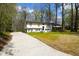 Beautiful two-story home with mature trees, freshly painted white brick and lush landscaping at 947 Manchester Dr, Cary, NC 27511