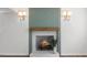 Close-up of a stylish fireplace with a wooden mantel and a decorative green backdrop at 947 Manchester Dr, Cary, NC 27511