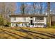Inviting two-story home featuring a well-kept lawn and a charming painted brick facade at 947 Manchester Dr, Cary, NC 27511