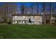 Inviting two-story home featuring a manicured lawn and a charming painted brick facade at 947 Manchester Dr, Cary, NC 27511