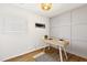 Bright home office with a modern desk, panelled wall, and a neutral decor at 947 Manchester Dr, Cary, NC 27511