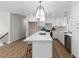 Bright, updated kitchen with white cabinets, quartz countertops, and stainless steel appliances at 947 Manchester Dr, Cary, NC 27511