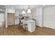Bright kitchen featuring white cabinets, an island with seating, and modern pendant lighting at 947 Manchester Dr, Cary, NC 27511