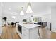 Open-concept kitchen with island seamlessly flowing into the living and dining areas at 947 Manchester Dr, Cary, NC 27511