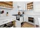 Modern kitchen with stainless steel appliances, white cabinetry, and stylish backsplash at 947 Manchester Dr, Cary, NC 27511