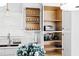 Bright kitchen with custom white cabinets, marble countertops, and stainless steel sink at 947 Manchester Dr, Cary, NC 27511