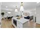 Open concept kitchen with quartz island, dining area and living room at 947 Manchester Dr, Cary, NC 27511