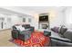 Comfortable living room with grey couches, a fireplace, a TV on the wall, and vinyl floors at 947 Manchester Dr, Cary, NC 27511