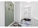 Well-organized mud room with hooks, dog bed, and stylish checkered flooring at 947 Manchester Dr, Cary, NC 27511