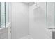 This glass shower is lined with white tile and has a rain shower head at 947 Manchester Dr, Cary, NC 27511