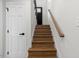 Staircase with wooden steps, white risers, and dark hardware at 947 Manchester Dr, Cary, NC 27511