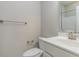 Cozy bathroom featuring a toilet, vanity with a sink, and a large mirror at 996 Tender Dr, Apex, NC 27502
