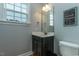 Cozy bathroom featuring a dark vanity with white countertops, a modern mirror, and neutral wall colors for a relaxing atmosphere at 996 Tender Dr, Apex, NC 27502