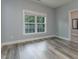 Bright bedroom with a large window, neutral walls, and stylish flooring, perfect for relaxation at 996 Tender Dr, Apex, NC 27502