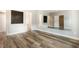 Spacious bedroom with modern flooring, neutral walls, and ample natural light with ensuite bathroom at 996 Tender Dr, Apex, NC 27502