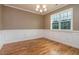 Bright dining room featuring elegant trim work, hardwood floors, and a large window providing ample natural light at 996 Tender Dr, Apex, NC 27502
