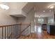 Inviting entryway featuring hardwood floors, staircase with black iron railings, and a seamless transition to the kitchen area at 996 Tender Dr, Apex, NC 27502