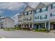 Inviting exterior showcasing colorful townhomes, lush landscaping, and a well-maintained street for curb appeal at 996 Tender Dr, Apex, NC 27502