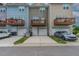 View of townhomes with attached garages and upper level wood balconies at 996 Tender Dr, Apex, NC 27502
