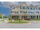 Charming exterior of townhomes with inviting front porches, colorful facades, and manicured landscaping at 996 Tender Dr, Apex, NC 27502