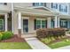 Inviting front porch with stone accents, a cozy entryway, and well-maintained landscaping at 996 Tender Dr, Apex, NC 27502