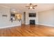 Open-concept living space with hardwood floors, a fireplace, and seamless flow into a kitchen, ideal for entertaining guests at 996 Tender Dr, Apex, NC 27502